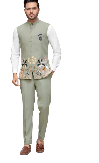 Man wearing embroidered sage green vest with white shirt and matching trousers.